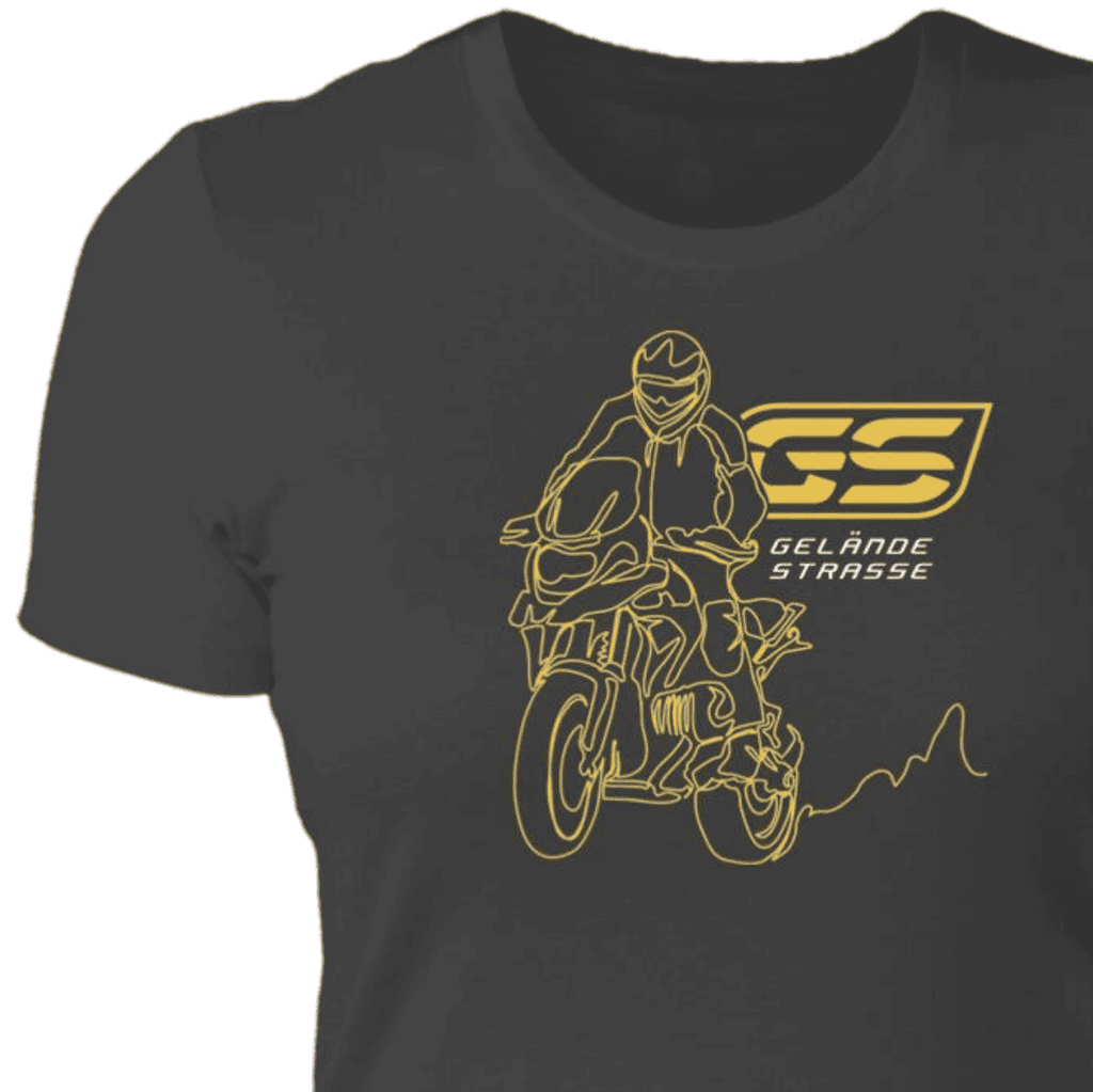 From Cannonball Adventure. This dark grey Women's fit t-shirt shows a BMW adventure motorcycle with rider standing on the foot pegs. The art is created in one, single line of the artist's pen. Text includes  German words "gelande / strasse", which translates to "off-road terrain / street" or the two type of roads you can travel with your adventure bike.